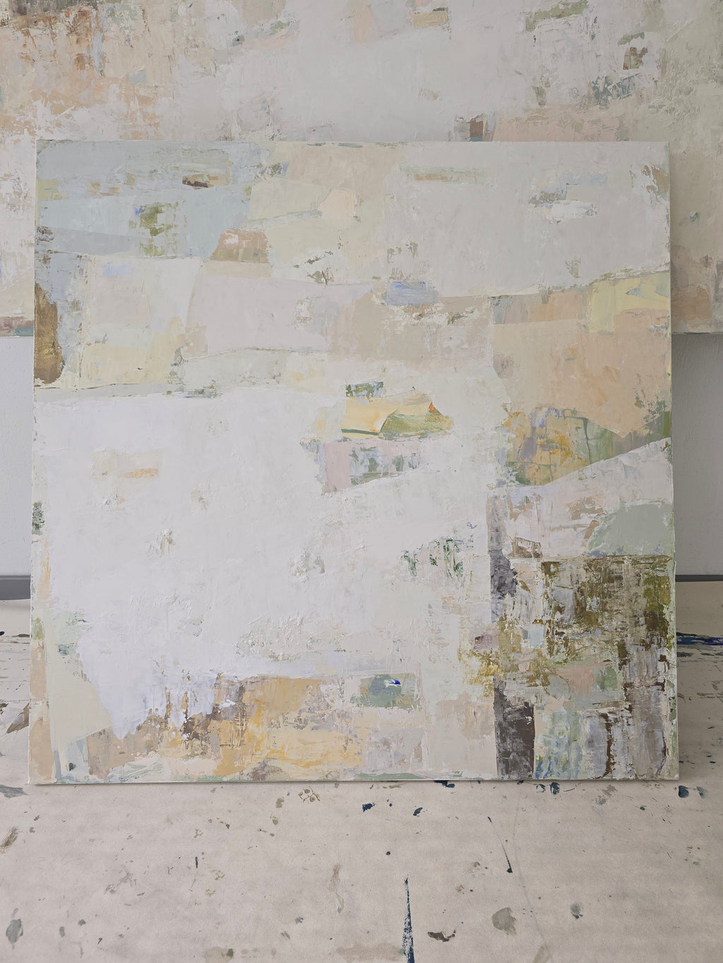 An abstract canvas painting featuring a textured, layered composition of off-white, beige, and soft pastel tones | Birute Studio