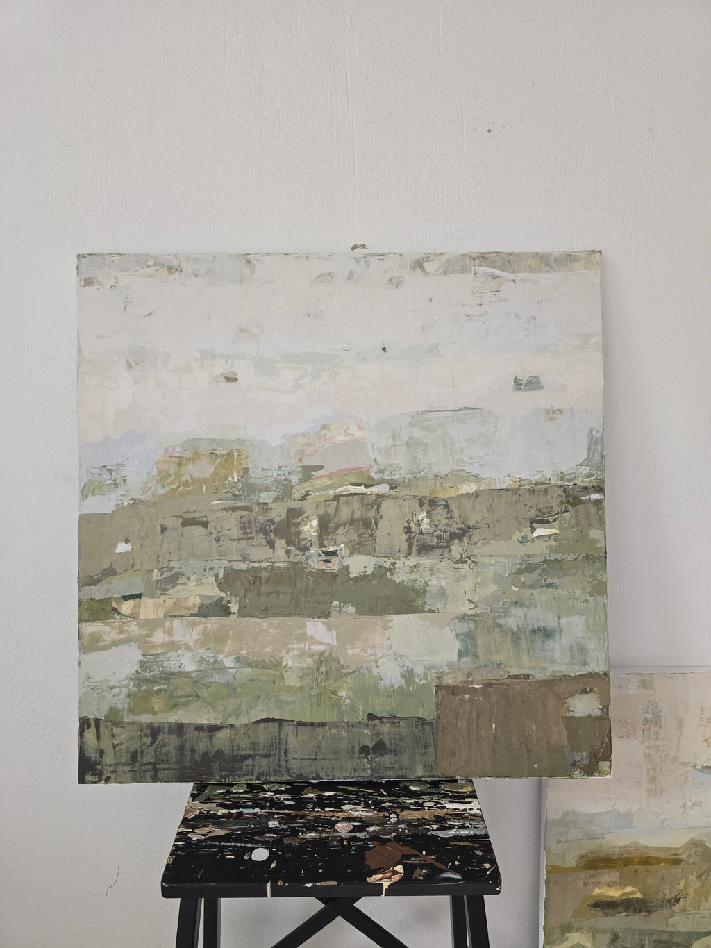 Abstract painting close-up with layered, textured surfaces in soft off-white, gray, beige, muted green, and brown tones. Created by Birute Studio.