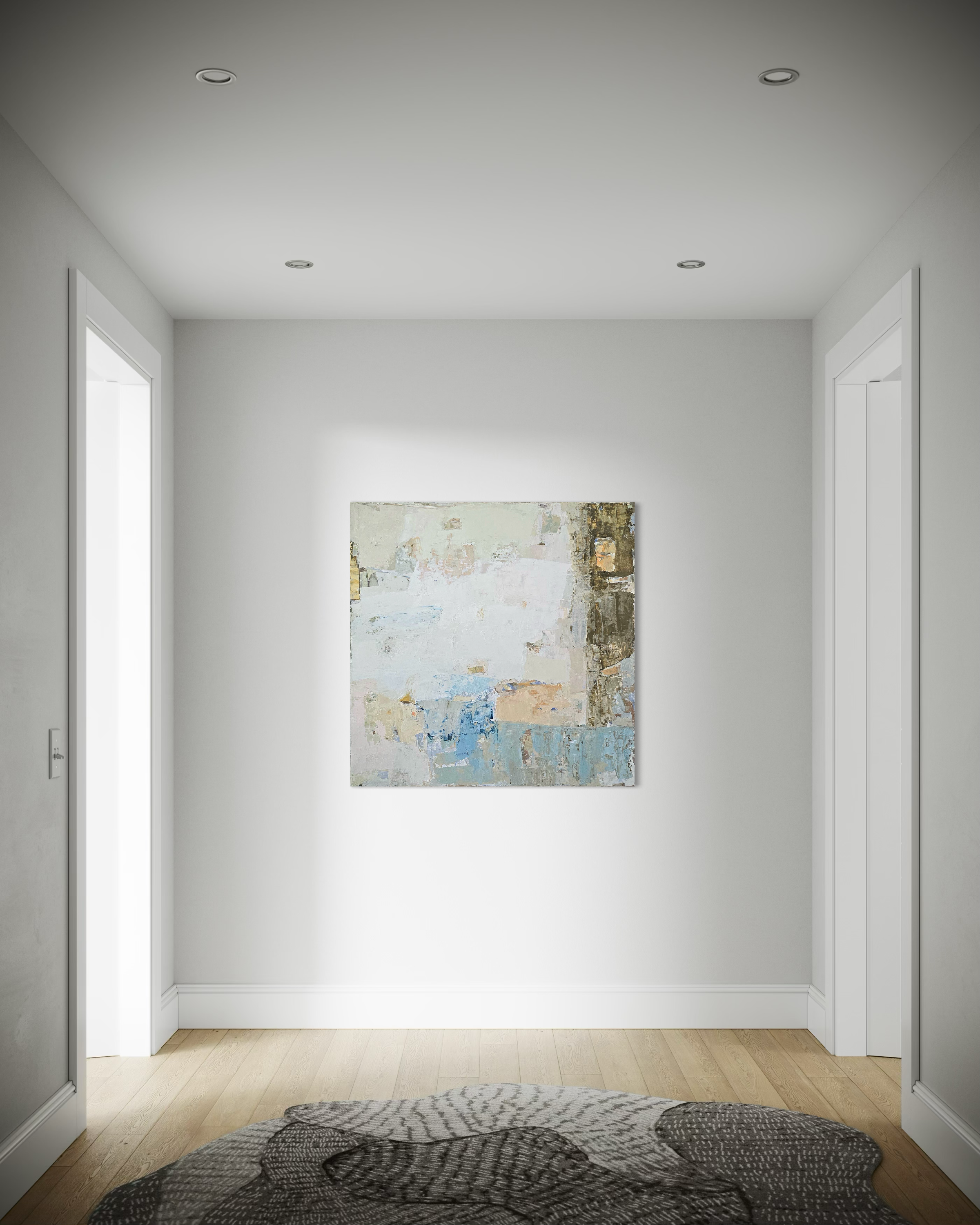 An abstract canvas painting with blue, beige, and white tones displayed on a white wall in a modern hallway with light wood floors.