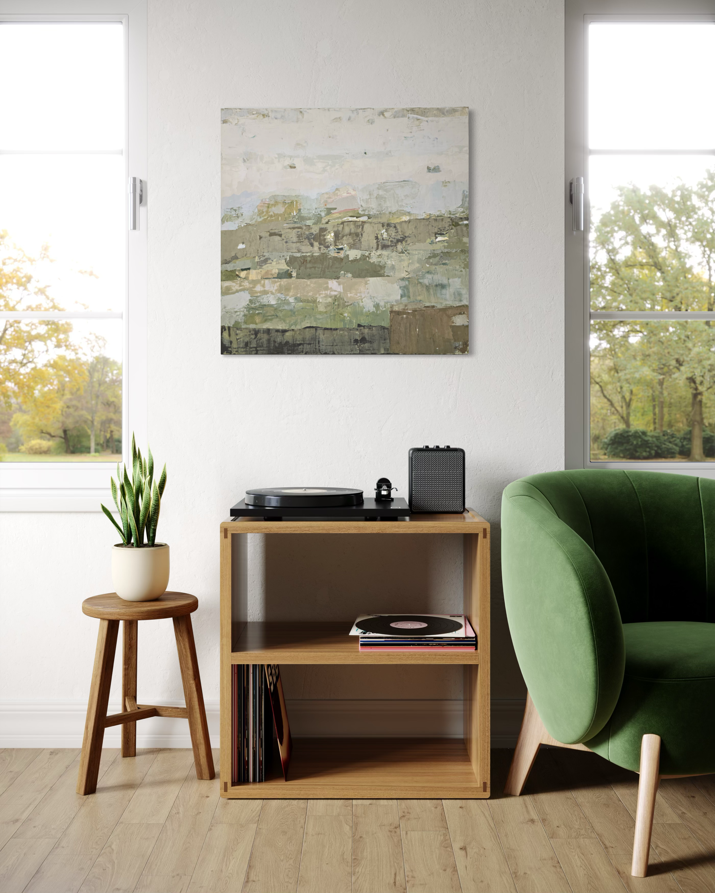 An abstract canvas painting created by Birute Studio in muted green, beige, and gray tones hangs on a white wall in a bright, modern living room. Below the painting is a light wood shelf holding a turntable, records, and a small speaker, next to a green armchair and a small wooden stool with a potted plant.