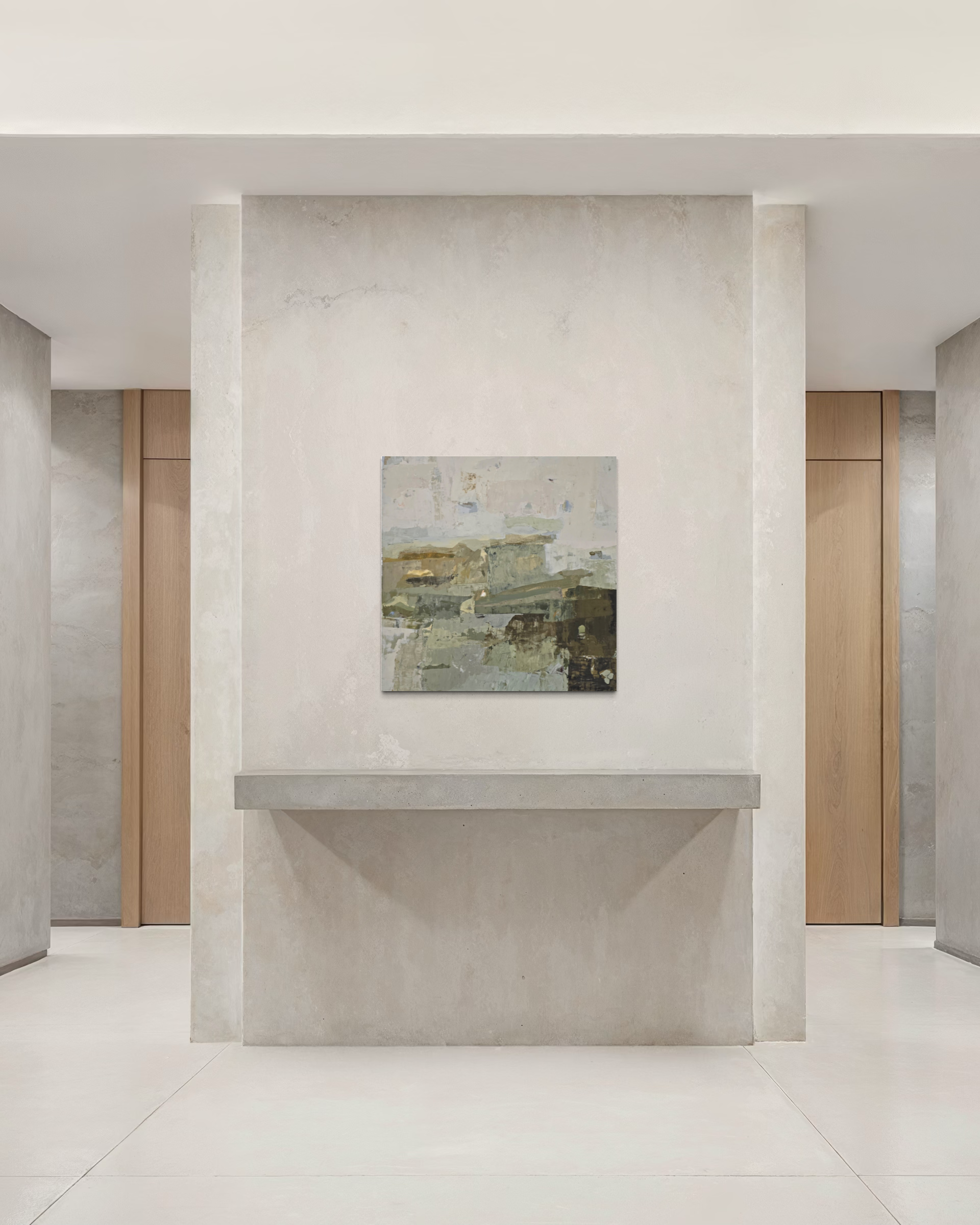 An abstract landscape painting in muted earthy tones hangs on a textured light gray stone wall above a matching stone shelf in a minimalist, modern interior hallway.